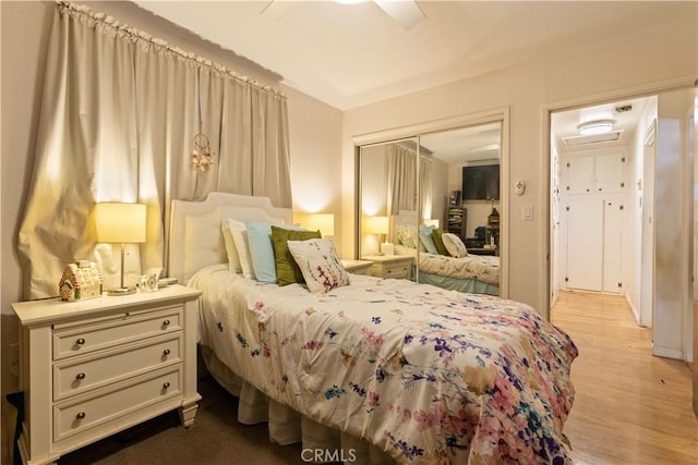 bedroom featuring ceiling fan, a closet, and light wood-type flooring