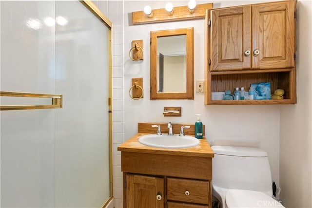 bathroom featuring vanity, toilet, and a shower with door