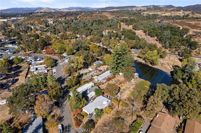 birds eye view of property with a water and mountain view