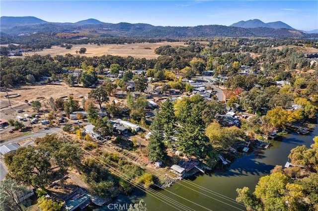 birds eye view of property featuring a water and mountain view