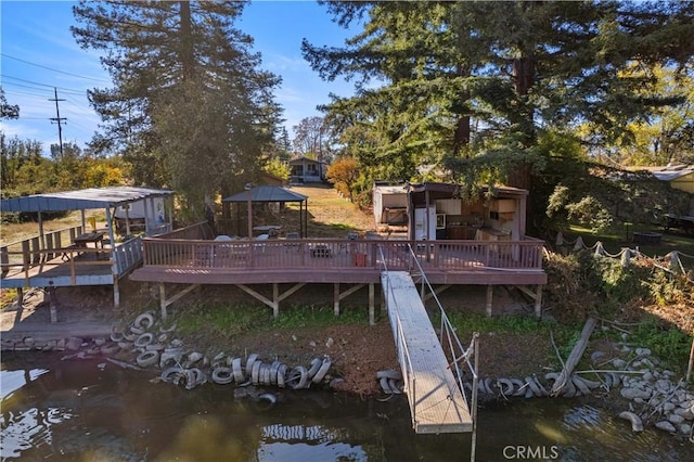 rear view of property featuring a deck with water view