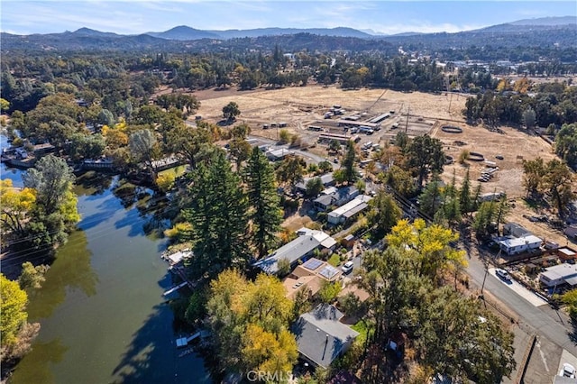 birds eye view of property with a water and mountain view