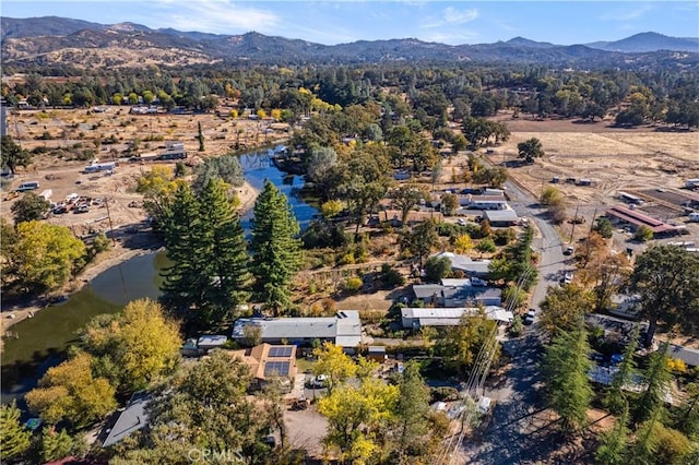 aerial view featuring a water and mountain view