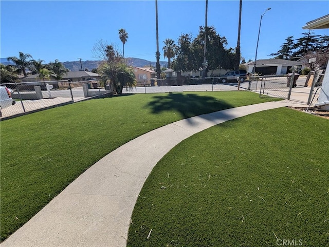 view of home's community featuring a lawn