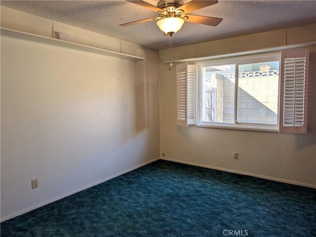 unfurnished room featuring a textured ceiling, dark carpet, and ceiling fan