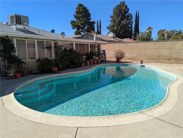 view of swimming pool with central AC unit