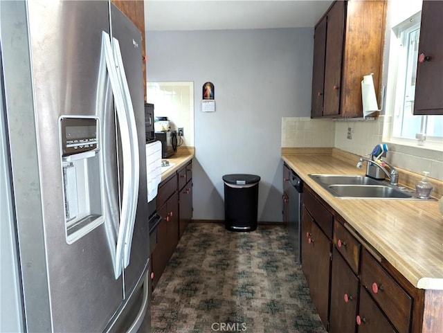 kitchen featuring backsplash, dark brown cabinets, sink, and stainless steel appliances