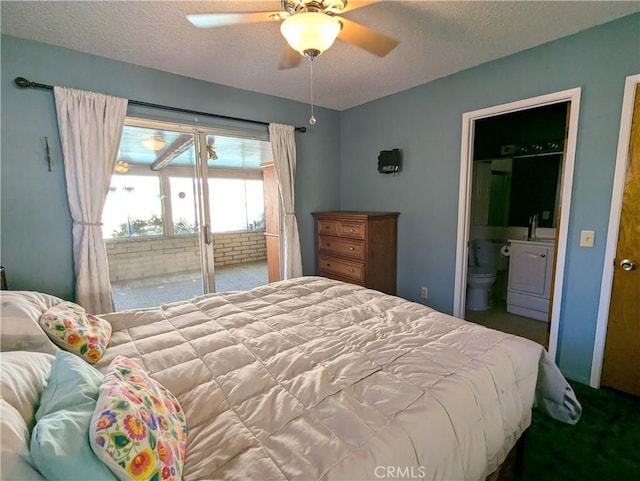 carpeted bedroom featuring a textured ceiling, washer / clothes dryer, ensuite bath, and ceiling fan