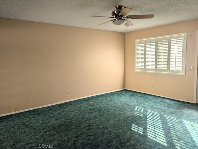 carpeted spare room with ceiling fan and a textured ceiling