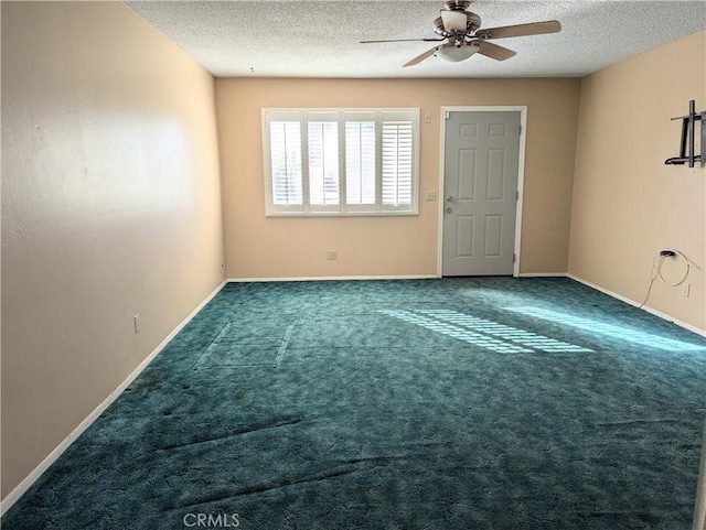 spare room with carpet flooring, ceiling fan, and a textured ceiling