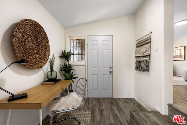 entryway with vaulted ceiling and dark hardwood / wood-style floors