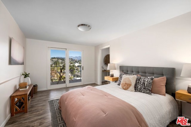 bedroom featuring dark hardwood / wood-style floors and access to outside