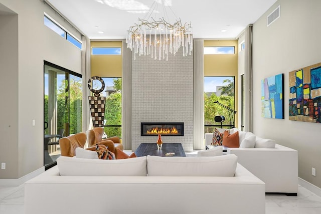 living room featuring a fireplace and a chandelier