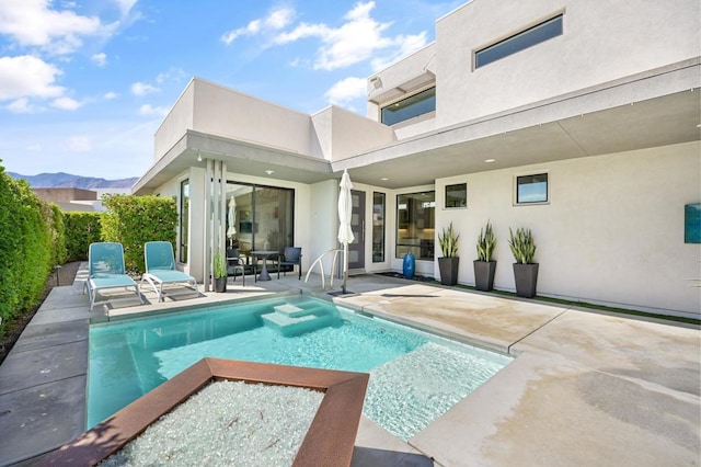 view of pool featuring a mountain view and a patio area