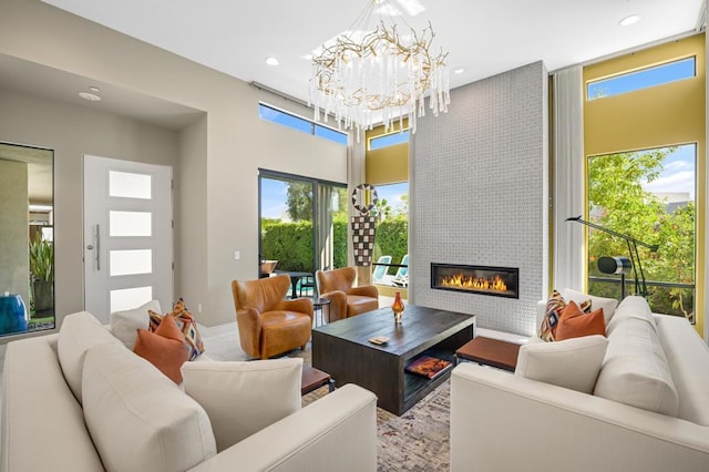 living room with a fireplace, wood-type flooring, and a notable chandelier