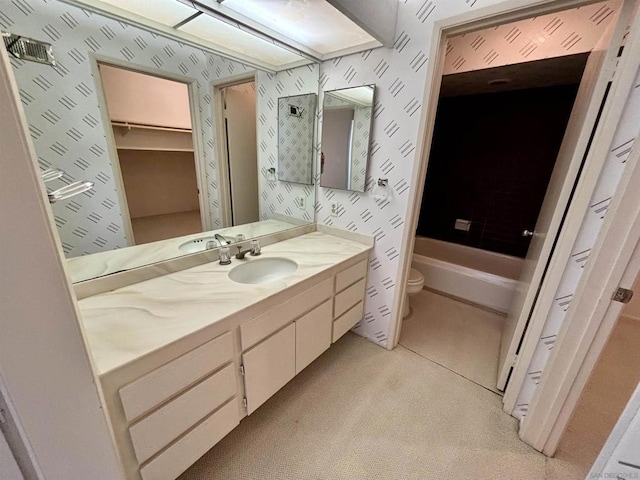 full bathroom with vanity, shower with separate bathtub, and toilet