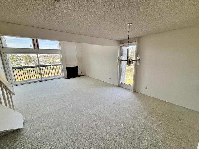 unfurnished living room with a textured ceiling and light carpet