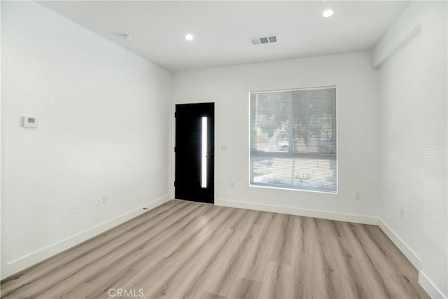 unfurnished room with light hardwood / wood-style floors