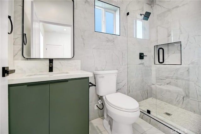 bathroom featuring toilet, vanity, tile walls, and a shower with door