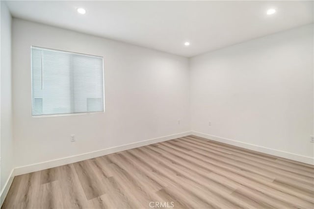 spare room with light wood-type flooring