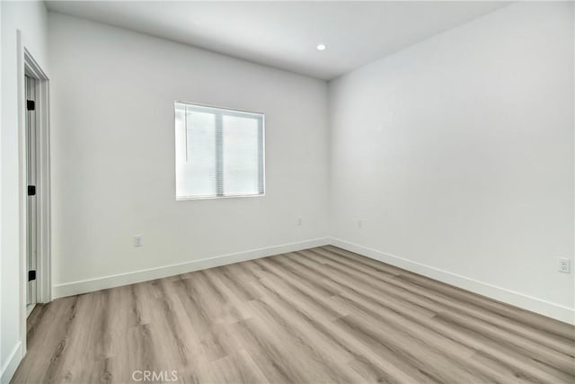 spare room with light hardwood / wood-style floors