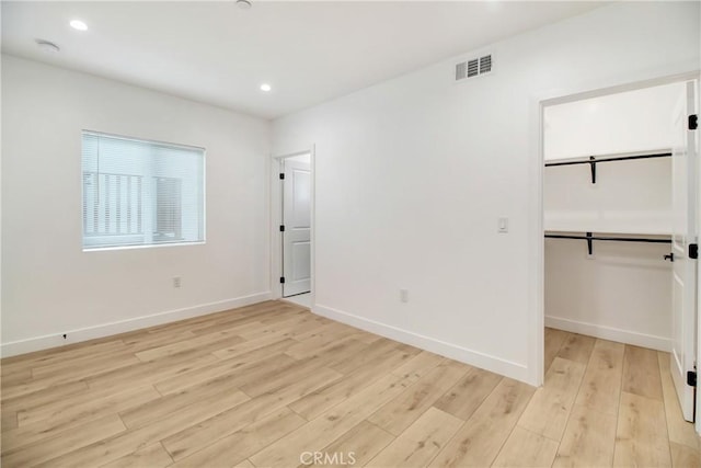 unfurnished room with light hardwood / wood-style flooring