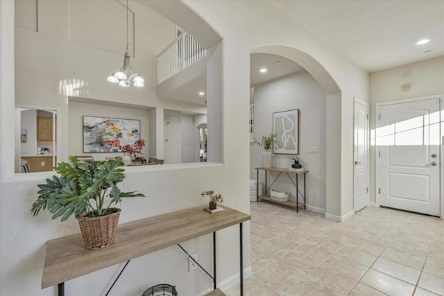 foyer featuring light tile patterned floors and a chandelier