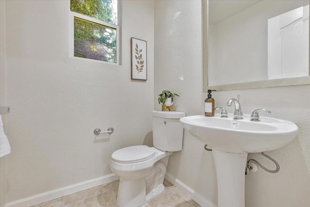 bathroom featuring tile patterned flooring and toilet