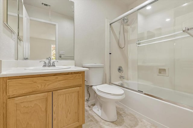 full bathroom with tile patterned floors, vanity, toilet, and shower / bath combination with glass door