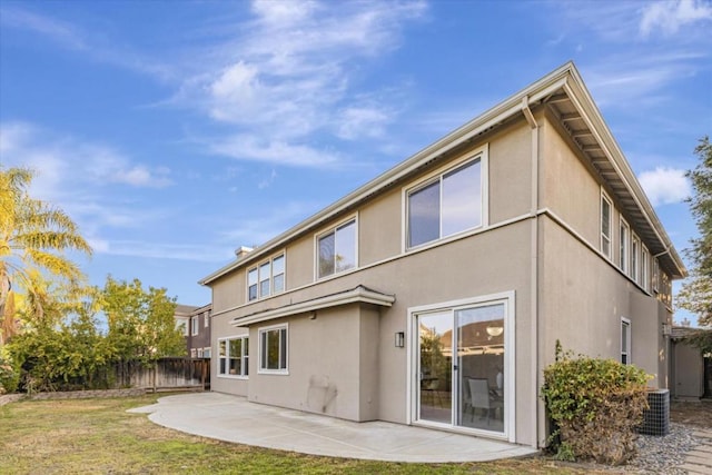 rear view of house featuring a patio area and a yard