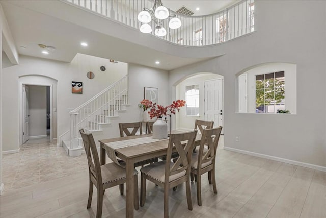 dining area with a high ceiling and a chandelier