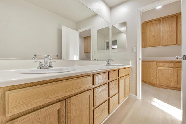 bathroom featuring hardwood / wood-style flooring and vanity