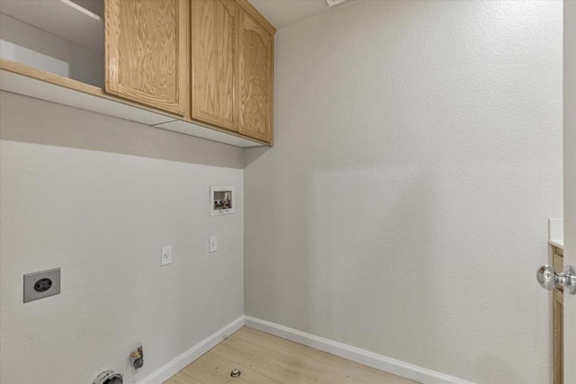 washroom with electric dryer hookup, cabinets, light hardwood / wood-style flooring, and washer hookup