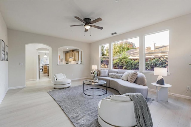 living room with light wood-type flooring and ceiling fan