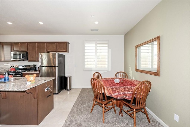 dining area with plenty of natural light and light tile patterned flooring