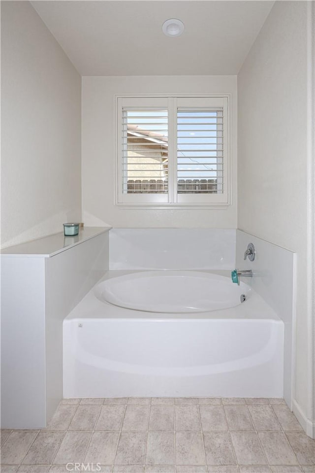 bathroom featuring a tub to relax in and tile patterned floors