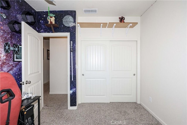 bedroom with carpet and a closet