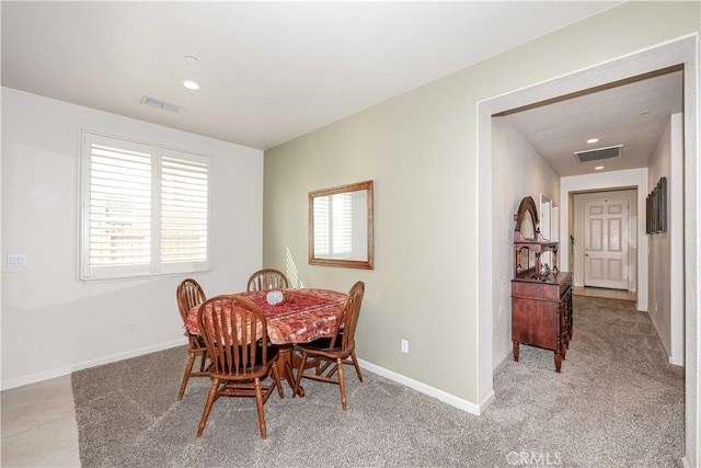 carpeted dining area with plenty of natural light