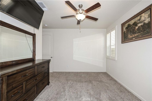 carpeted spare room with ceiling fan