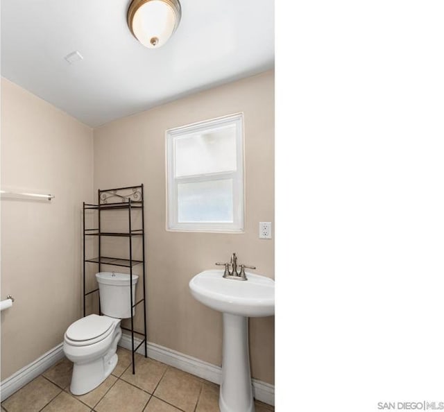 bathroom with tile patterned flooring and toilet