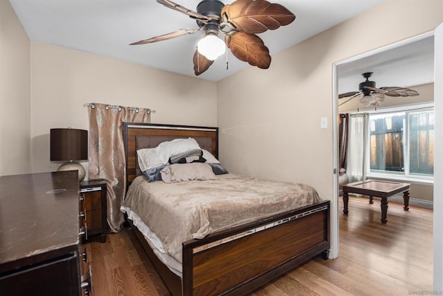 bedroom with hardwood / wood-style flooring and ceiling fan