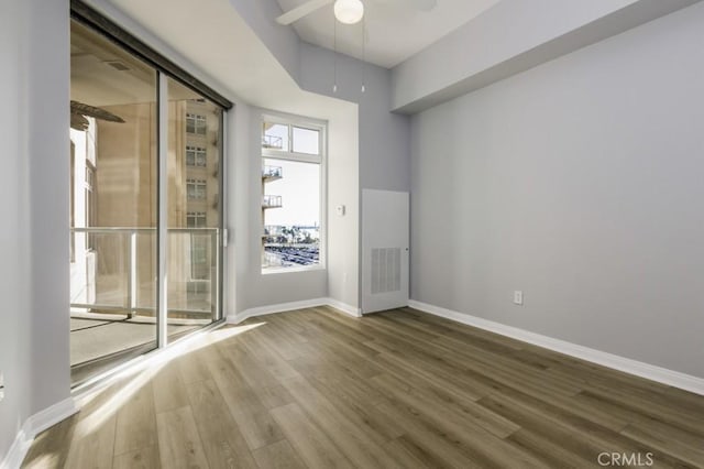 empty room featuring ceiling fan and hardwood / wood-style floors