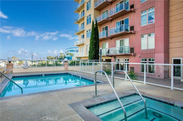 view of swimming pool featuring a community hot tub