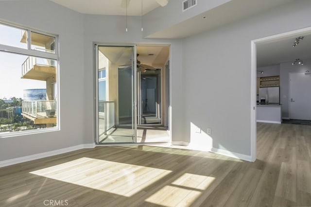 spare room with ceiling fan and hardwood / wood-style floors