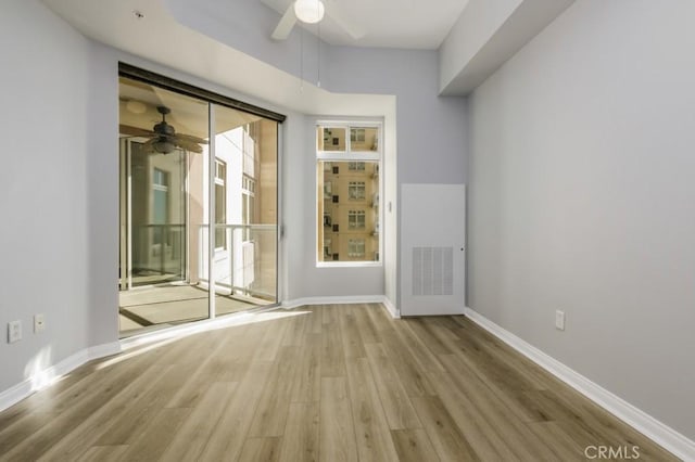 unfurnished room featuring light wood-type flooring and ceiling fan