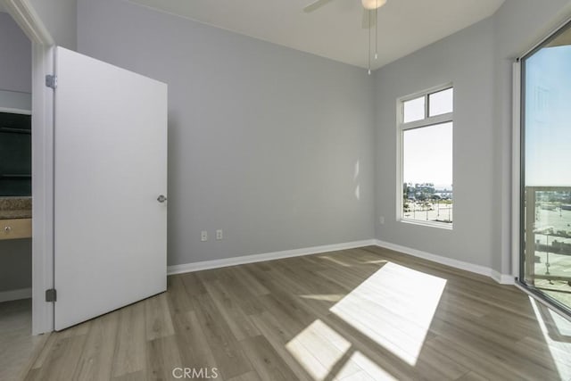 unfurnished room with ceiling fan and light hardwood / wood-style floors