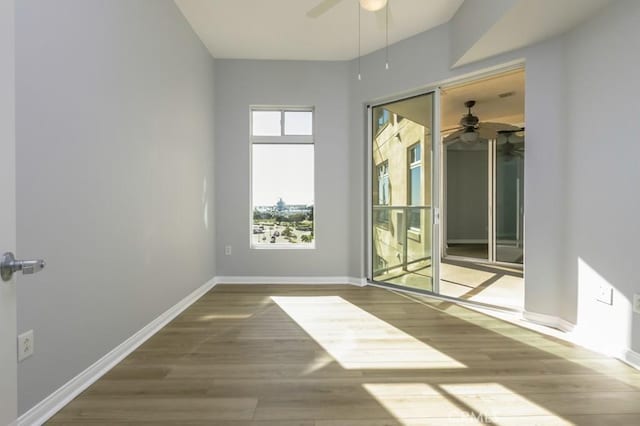 spare room with ceiling fan and hardwood / wood-style flooring