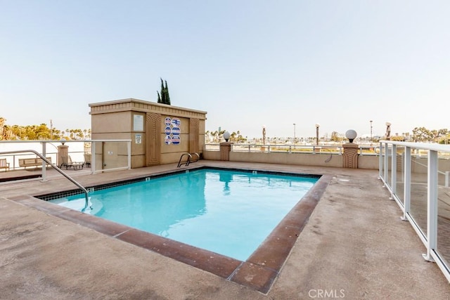 view of swimming pool featuring a patio area