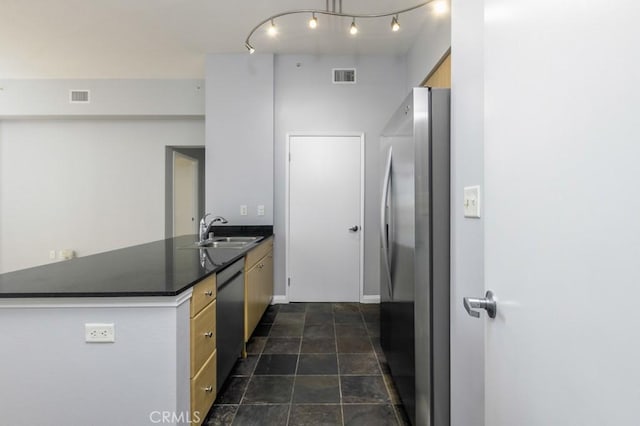 kitchen featuring kitchen peninsula, appliances with stainless steel finishes, and sink