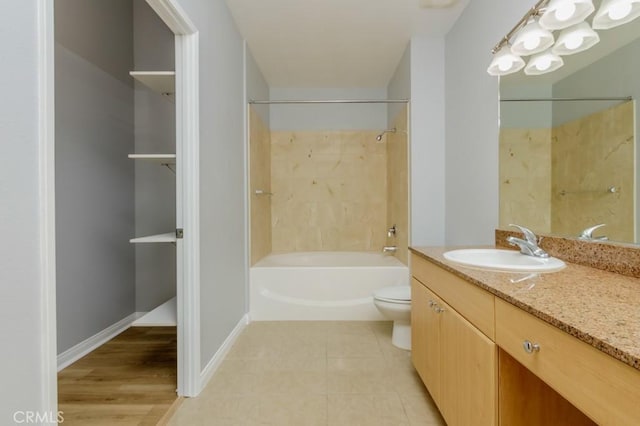 full bathroom with toilet, vanity,  shower combination, and tile patterned flooring